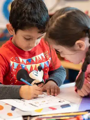 Two Montessori Students Working Together at Desk